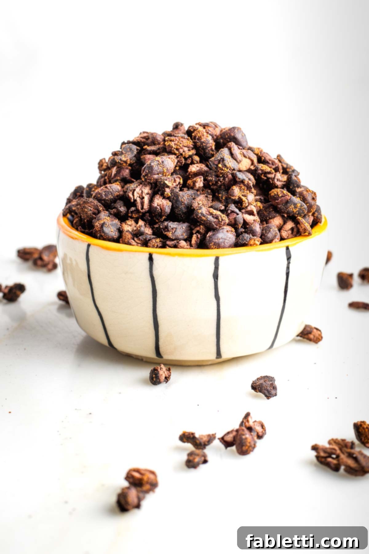 Crunchy Taco Black Beans 2 White bowl with black stripes filled with crispy roasted black beans. A close-up shot of the perfectly roasted, seasoned beans, highlighting their texture.