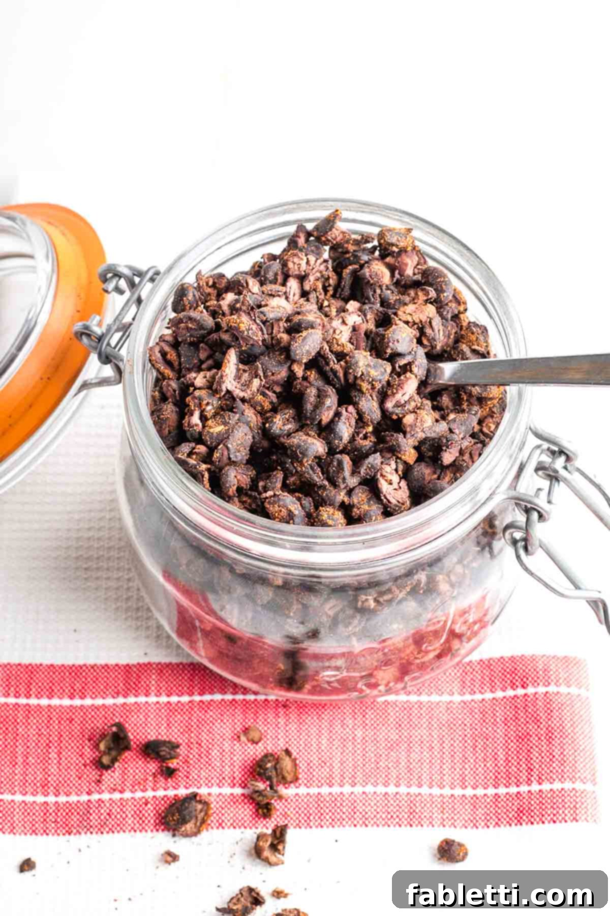 Crunchy Taco Black Beans 12 Lidded jar filled with crispy black beans, all on a tea towel with red stripe. An example of proper storage.