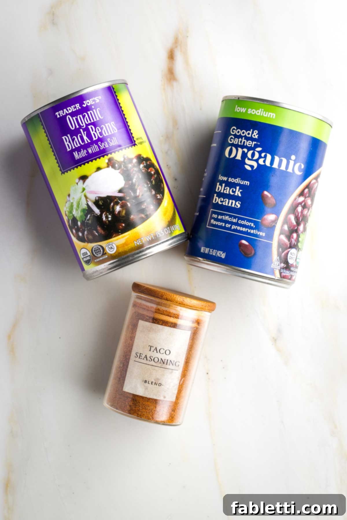 Crunchy Taco Black Beans 3 Two cans of black beans, one is low sodium, and a jar of No-salt taco seasoning. These are the two primary ingredients for the recipe.