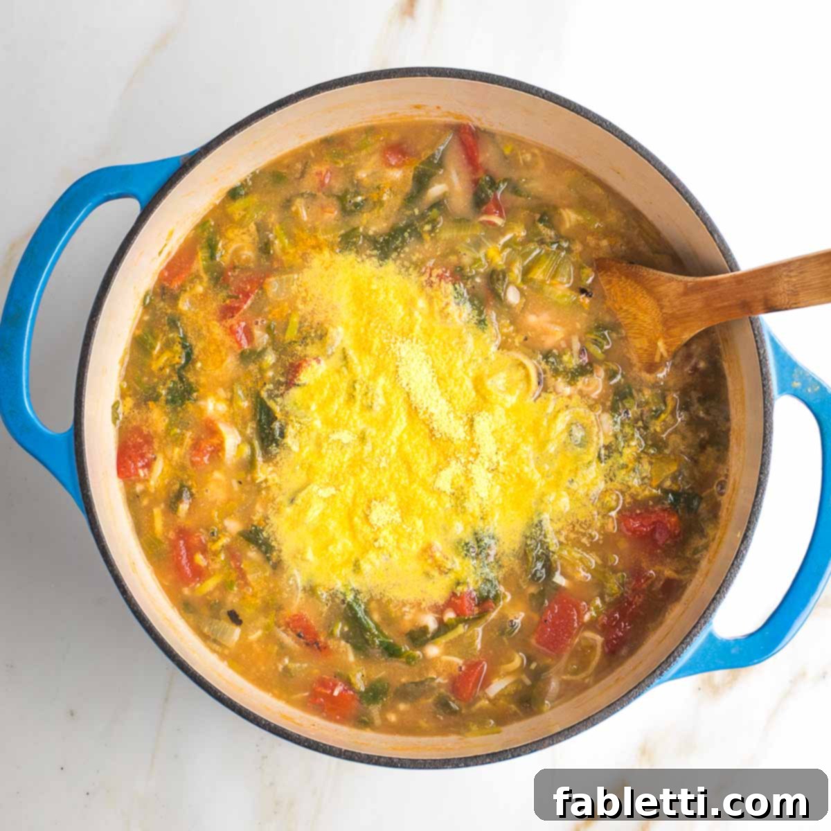 Nutritional yeast, sprinkled onto a pot of chunky soup.