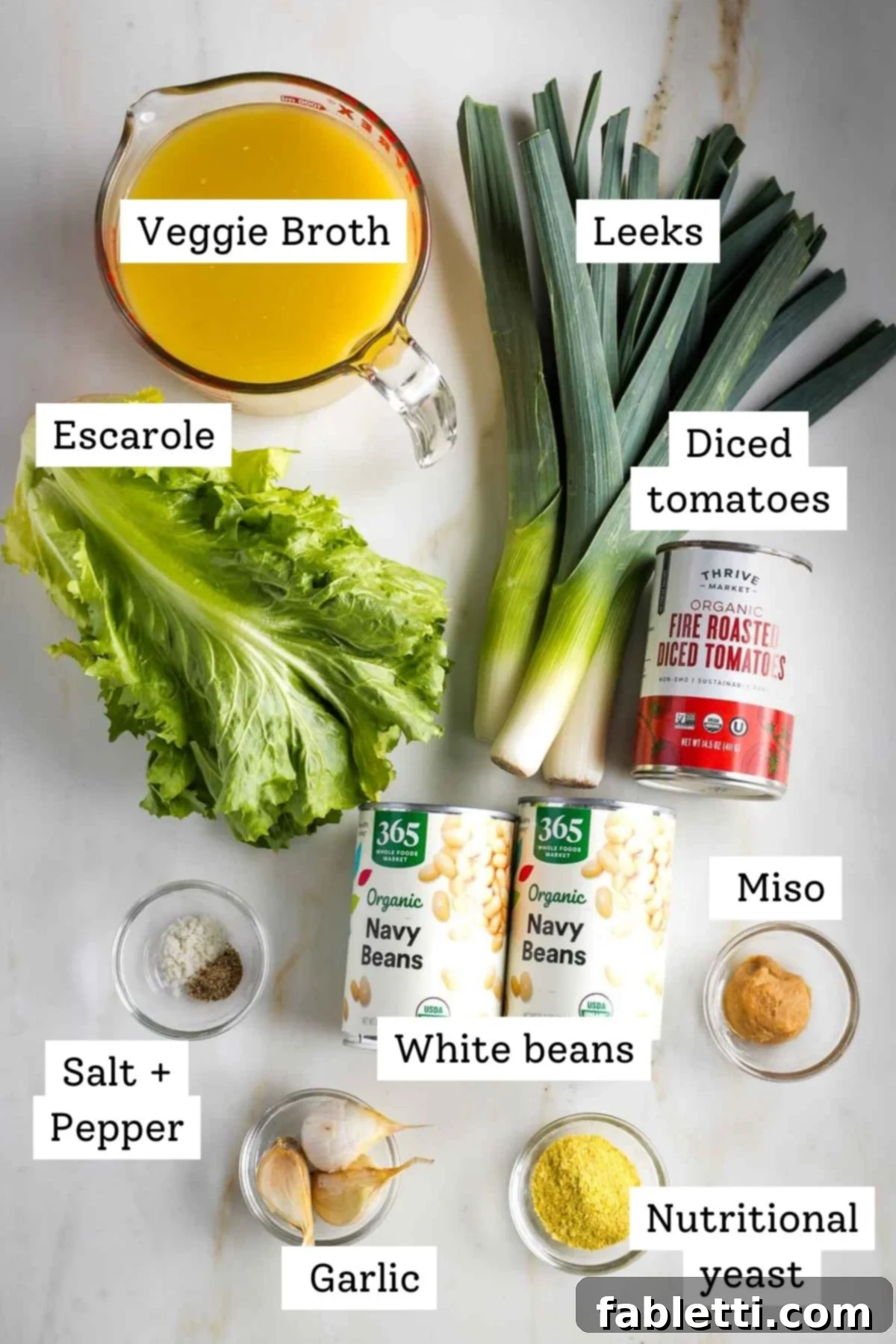 Labeled ingredients: broth, leeks, diced tomatoes, escarole, white beans, nutritional yeast, miso, garlic and spices.