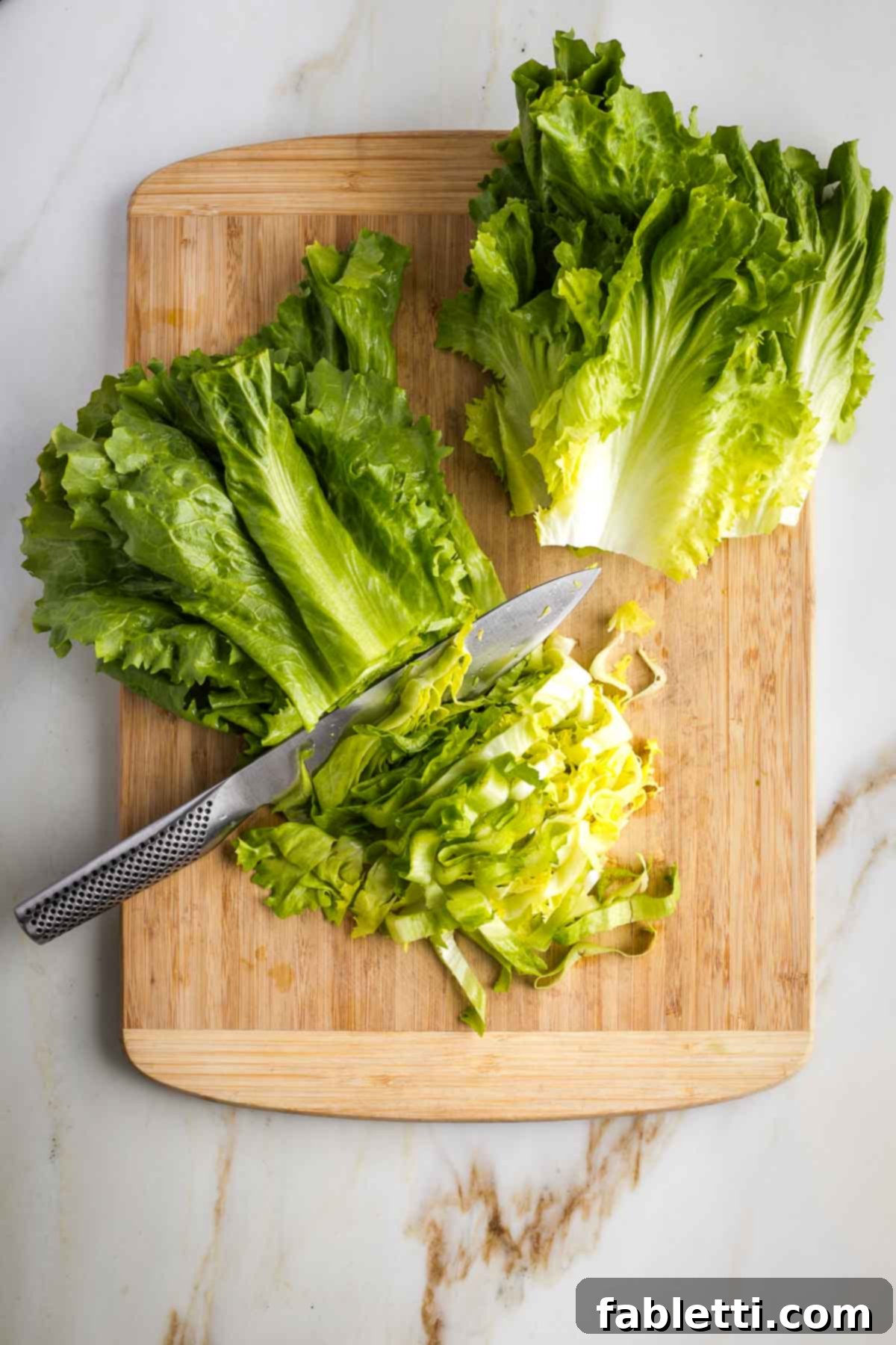 Escarole leaves stacked and cut into strips, both the dark green and the yellowish part. 