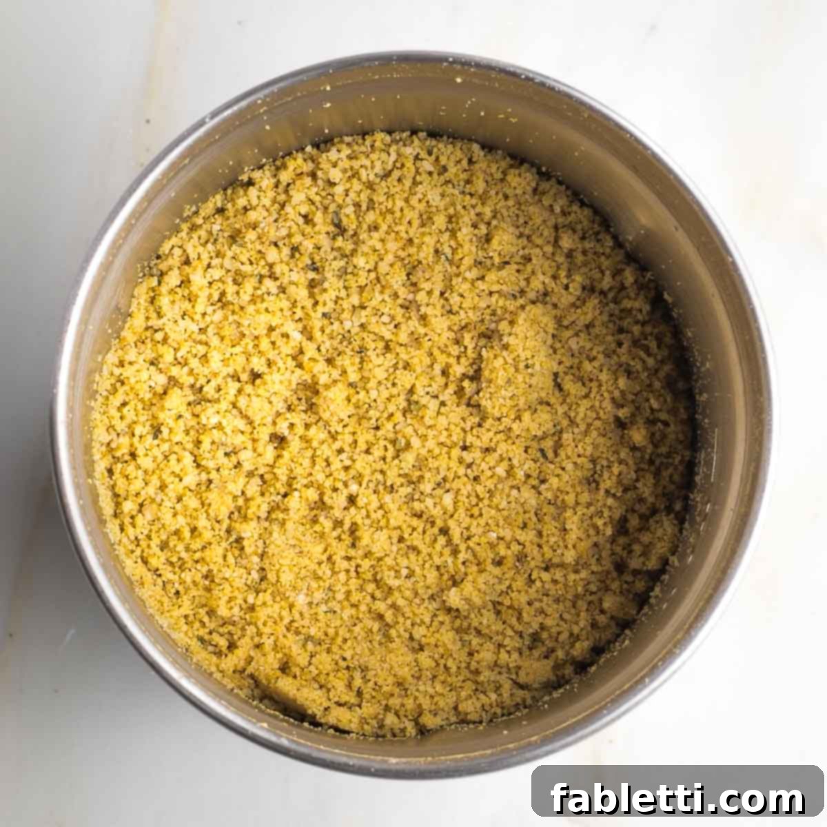 Luscious Vegan Parsnip Gratin 11 Spice grinder container with crumbly yellow mixture.