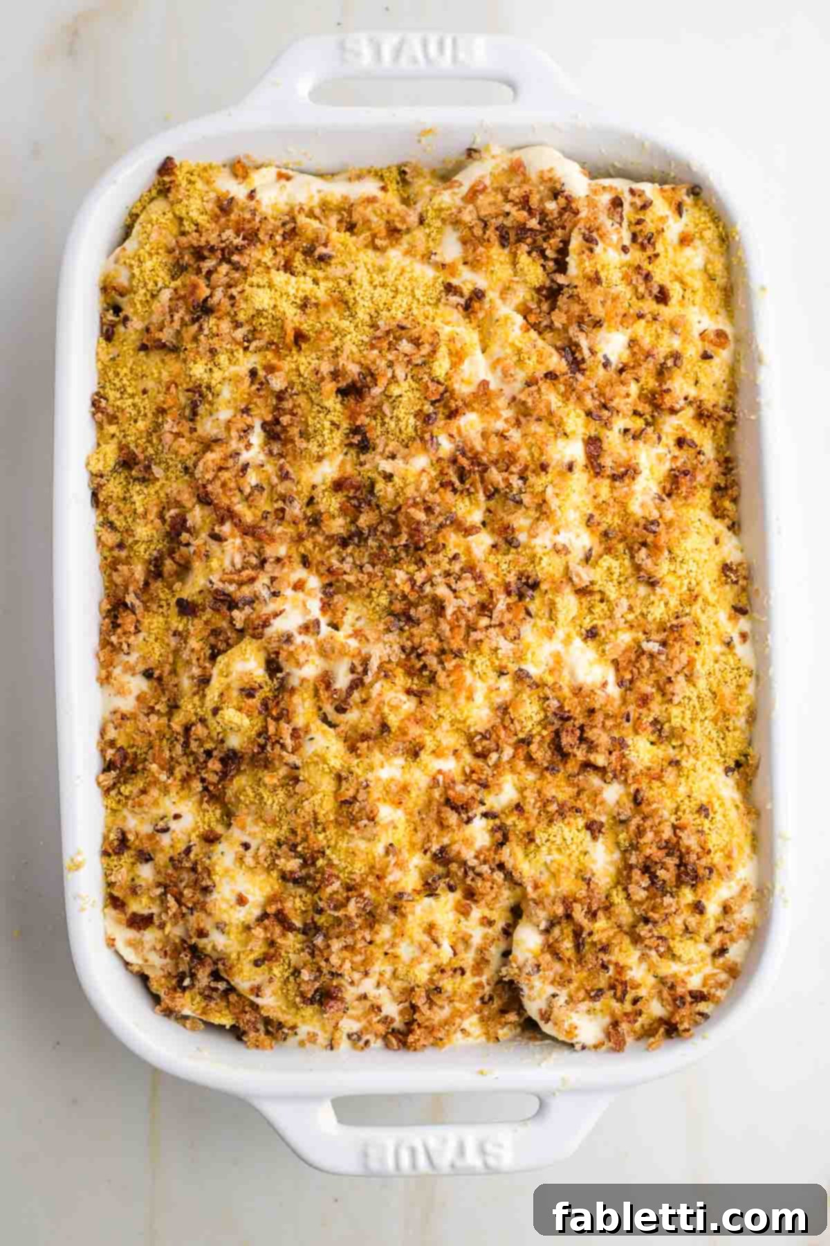 Luscious Vegan Parsnip Gratin 21 Layered parsnips with sauce, vegan parmesan, and breadcrumbs.