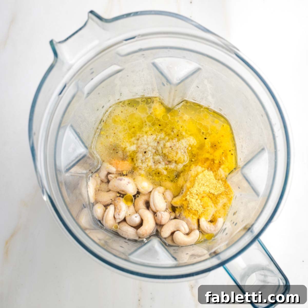 Luscious Vegan Parsnip Gratin 8 Blender with cashews, garlic, oil and nutritional yeast.