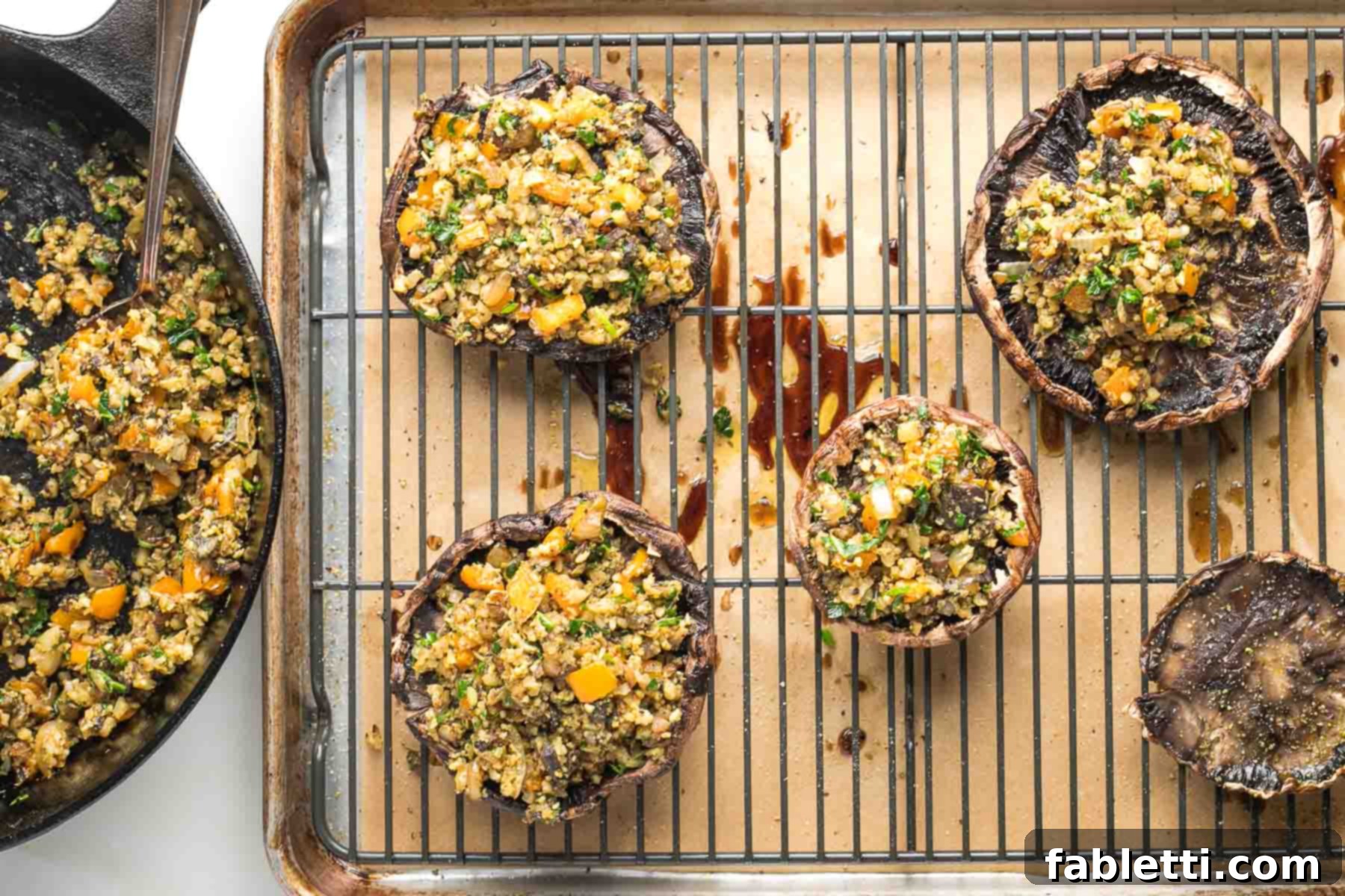 Gourmet Vegan Stuffed Portobello Mushrooms 15 Mushroom caps stuffed with veggie filling on a wire rack in a baking tray, ready for the final bake.