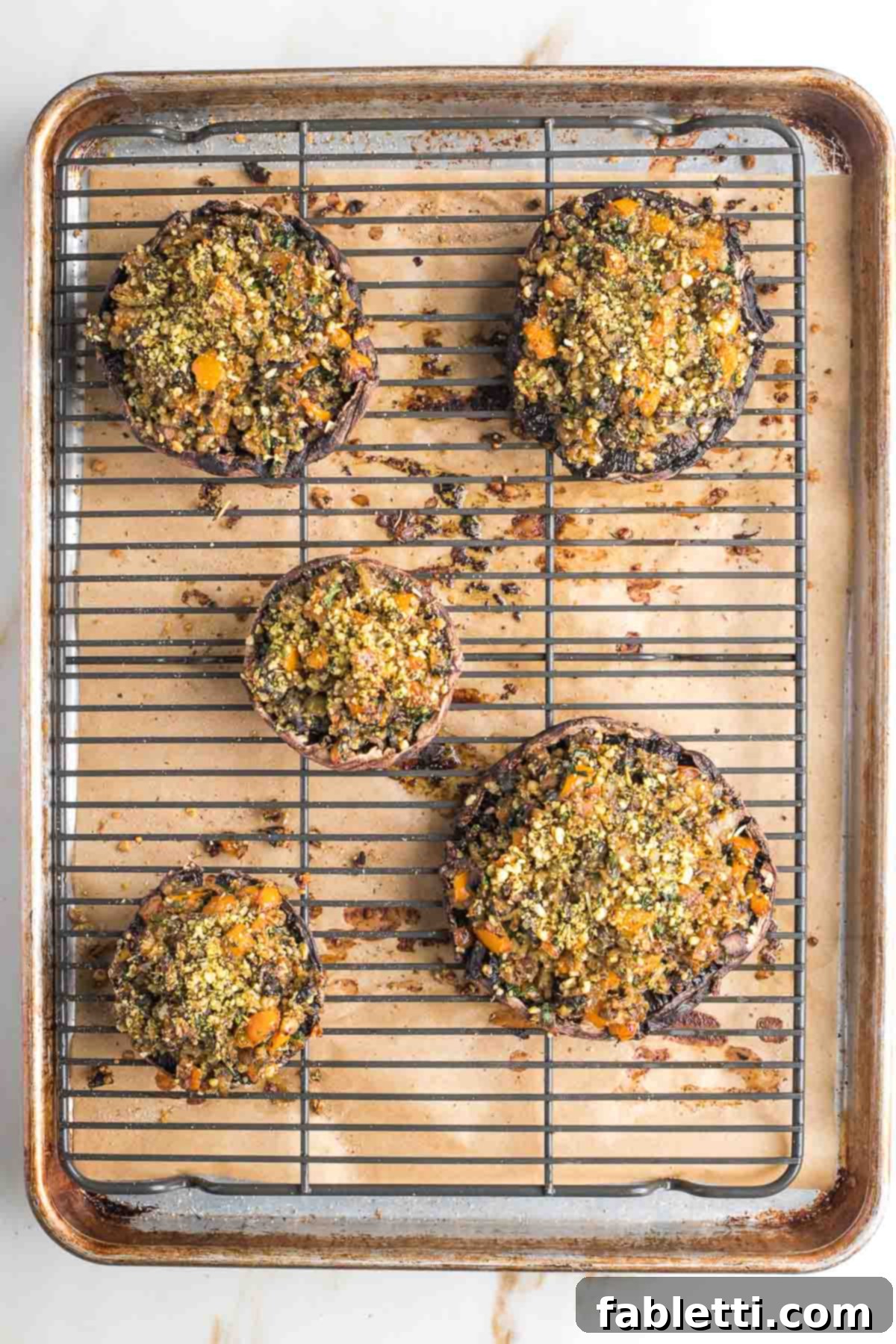 Gourmet Vegan Stuffed Portobello Mushrooms 16 Three fully baked vegan stuffed portobello mushrooms on a serving platter, ready to be enjoyed.
