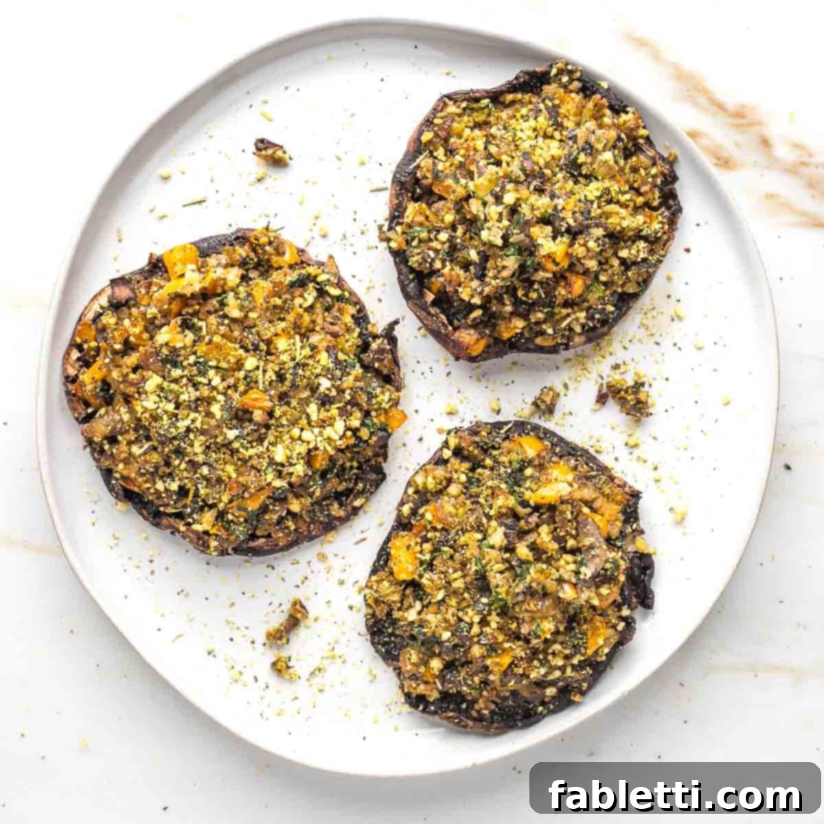 Gourmet Vegan Stuffed Portobello Mushrooms 17 A beautifully plated vegan stuffed portobello mushroom, freshly baked and garnished.