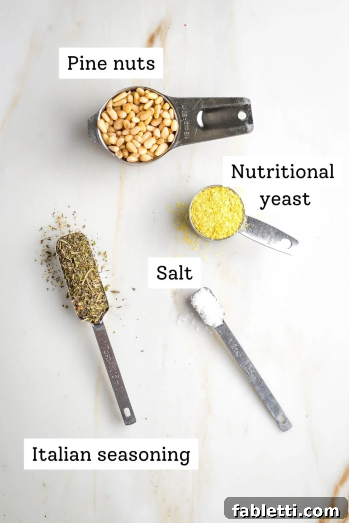 Gourmet Vegan Stuffed Portobello Mushrooms 5 Labeled ingredients for vegan parmesan cheese: pine nuts, Italian seasoning, nutritional yeast, and salt.