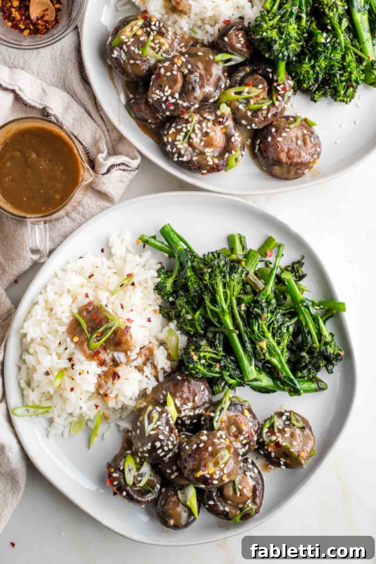 Umami-Rich Vegan Miso Mushrooms 2 Plate with saucy mushrooms, white rice and broccolini.
