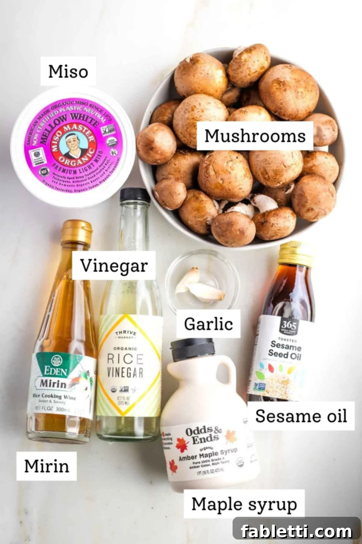 Umami-Rich Vegan Miso Mushrooms 3 A selection of fresh ingredients including miso paste, mirin, rice vinegar, mushrooms, garlic, and maple syrup.