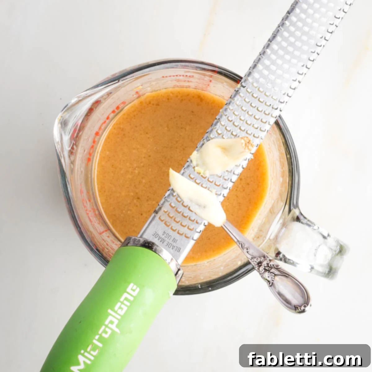 Umami-Rich Vegan Miso Mushrooms 5 A fork mixing miso paste, vinegar, mirin, maple syrup and sesame oil until smooth and creamy.