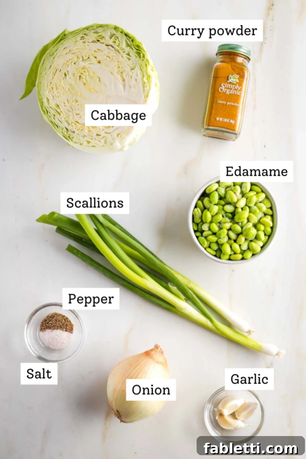 Speedy Skillet Curried Cabbage 3 Fresh ingredients for cabbage curry: green cabbage, yellow onion, garlic, curry powder, edamame, and scallions.