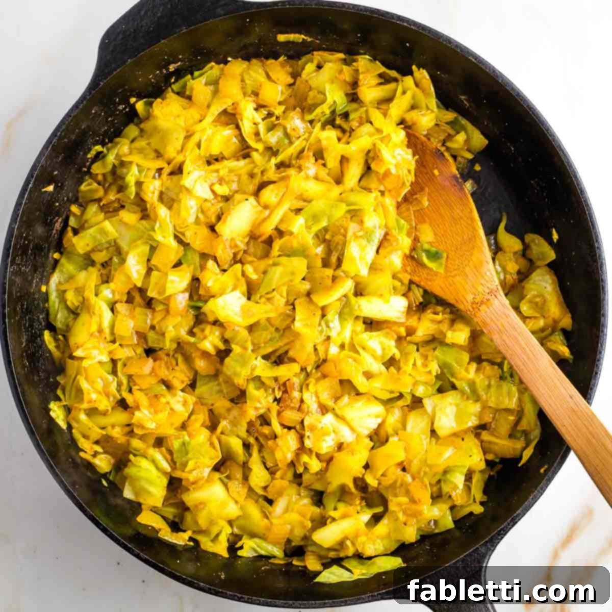 Speedy Skillet Curried Cabbage 7 Water being poured over cabbage and spices in a pan, before covering.