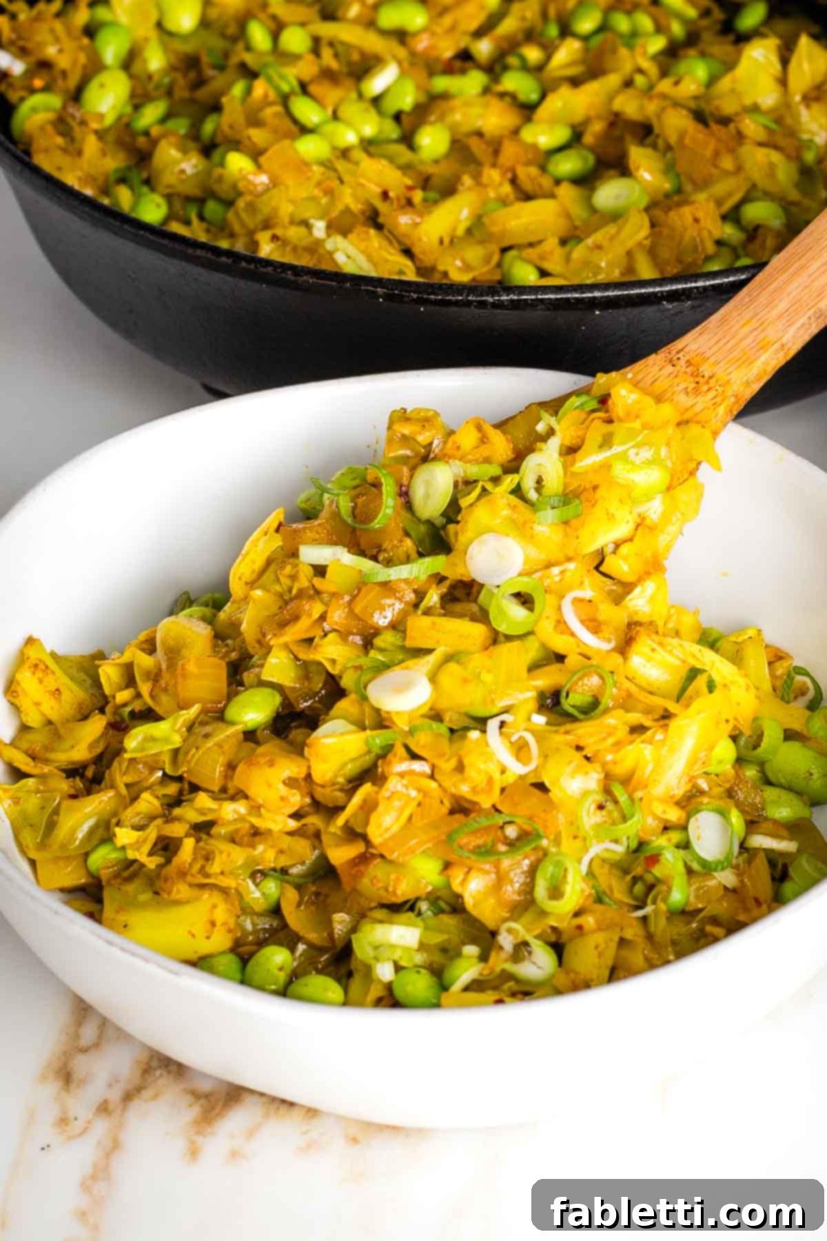 Speedy Skillet Curried Cabbage 10 Close-up of Cabbage Curry cooking in a skillet, showcasing the vibrant spices.