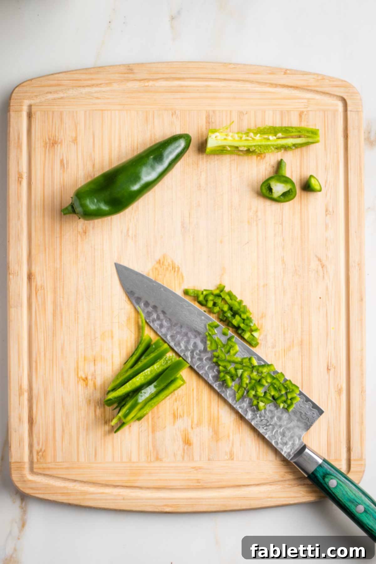 Spicy Vegan Skillet Jalapeño Cornbread 7 Showing how to dice a jalapeno by removing seeds and membranes, then cutting long strips and finally cutting across.