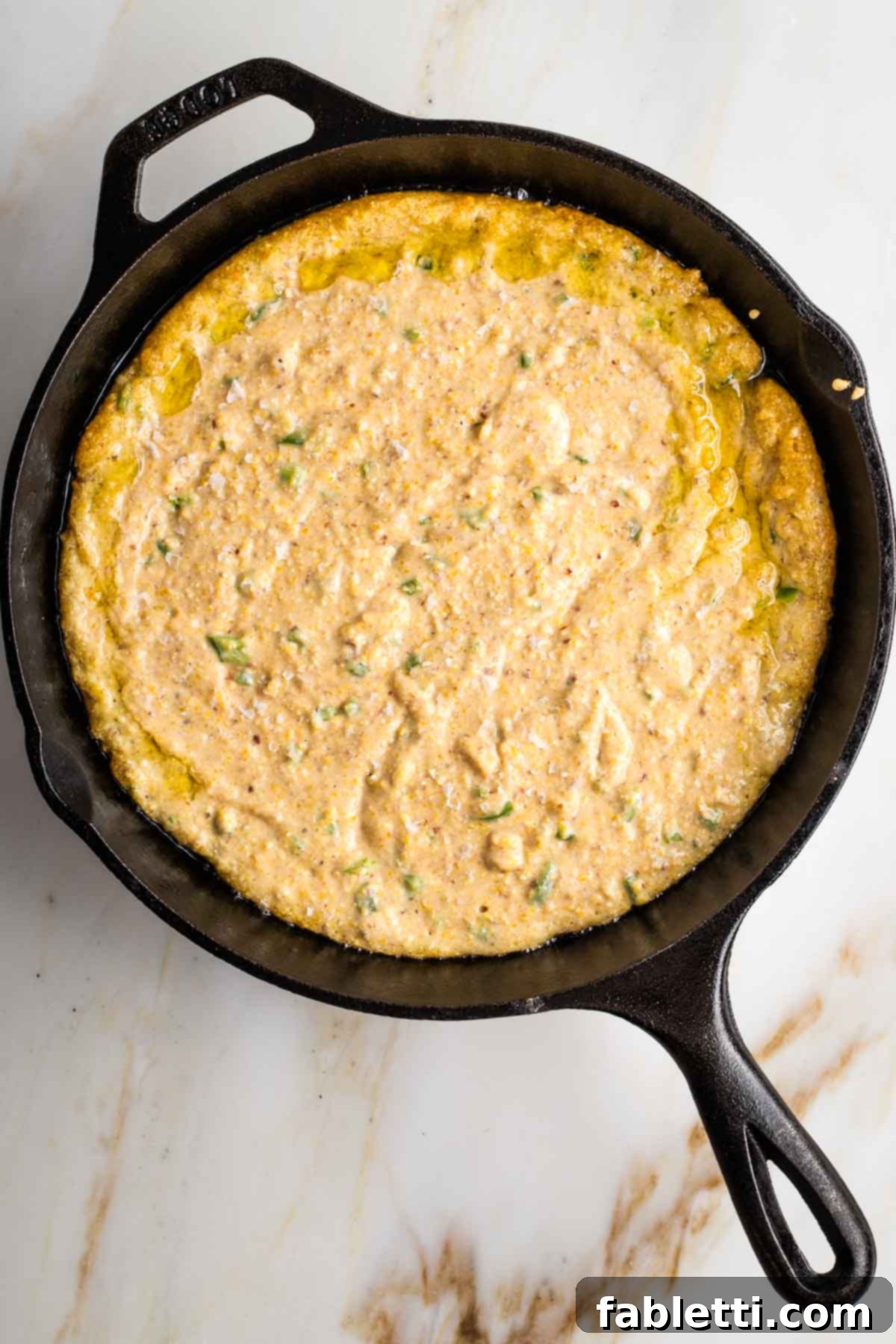 Spicy Vegan Skillet Jalapeño Cornbread 9 Cast iron skillet filled with cornbread batter.
