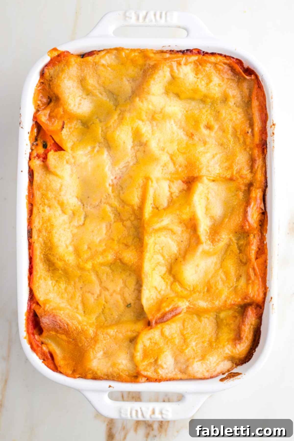 Lush Layers: Gluten-Free Vegan Garden Lasagna 13 Baked lasagna in a baking dish, sauce bubbling around the edges.