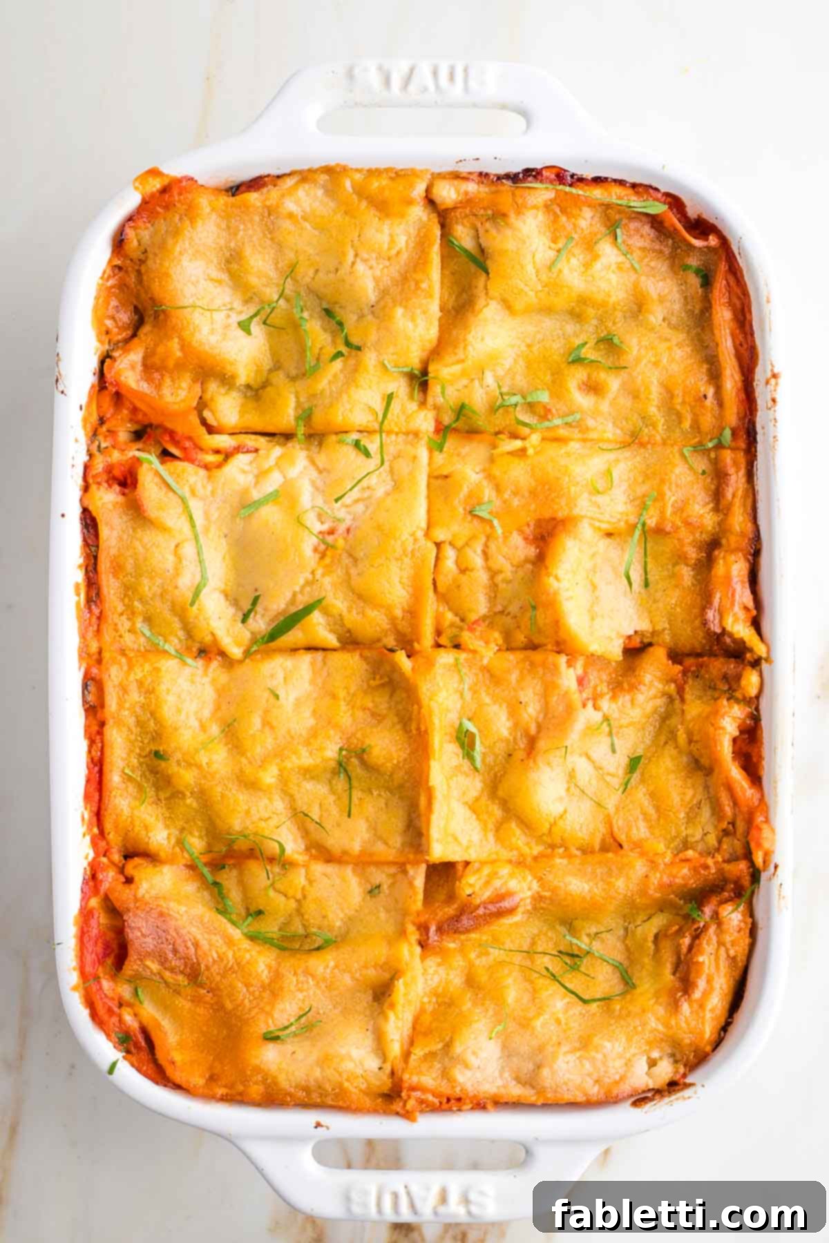 Lush Layers: Gluten-Free Vegan Garden Lasagna 14 Baked lasagna, cut into 8 pieces and sprinkled with fresh herbs.