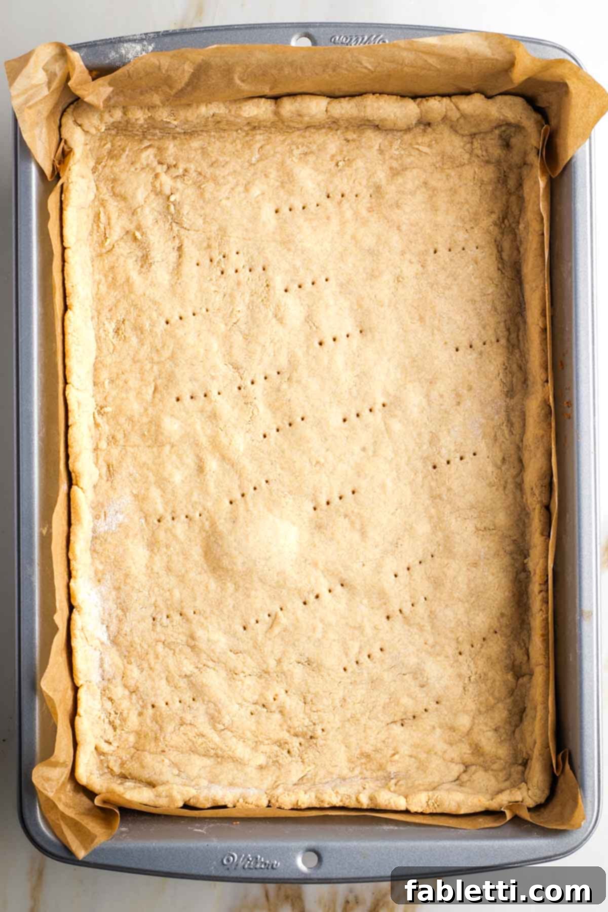 Naturally Sweetened Vegan Pecan Pie Bars 11 Prebaked pie crust on a rectangular pan.