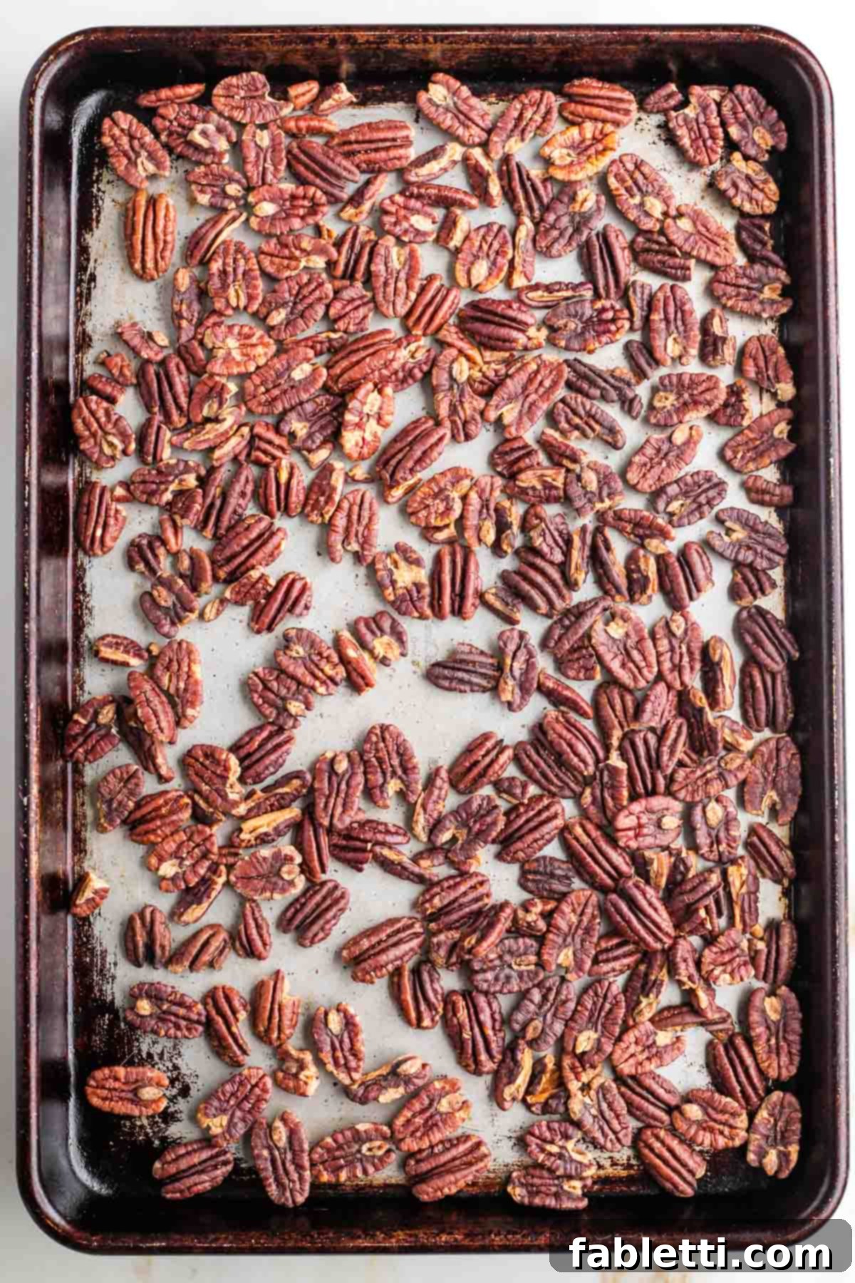 Naturally Sweetened Vegan Pecan Pie Bars 12 Deeply toasted, but not burnt pecans on a baking sheet.
