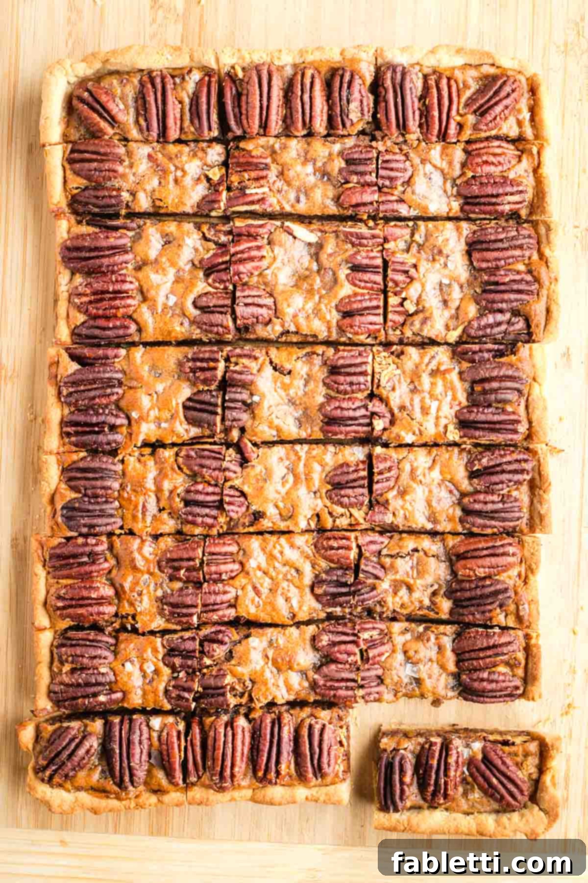 Naturally Sweetened Vegan Pecan Pie Bars 21 Large rectangle pecan pie cut into small pieces.