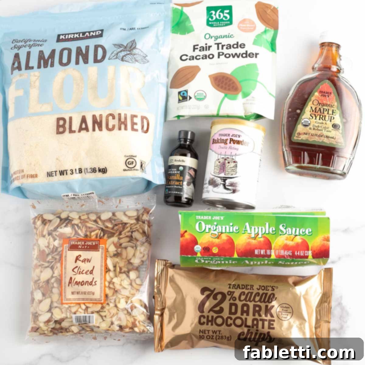 Irresistible Vegan Gluten-Free Chocolate Almond Biscotti 3 Ingredients for Chocolate Almond Biscotti laid out, including almond flour, cacao powder, applesauce, and sliced almonds.