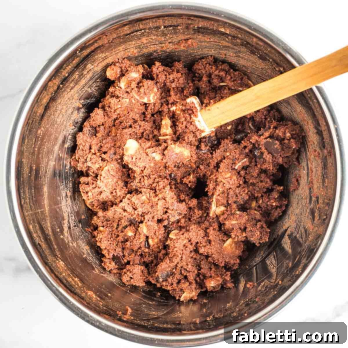 Irresistible Vegan Gluten-Free Chocolate Almond Biscotti 9 Chocolate cookie dough with chocolate chips and sliced almonds.