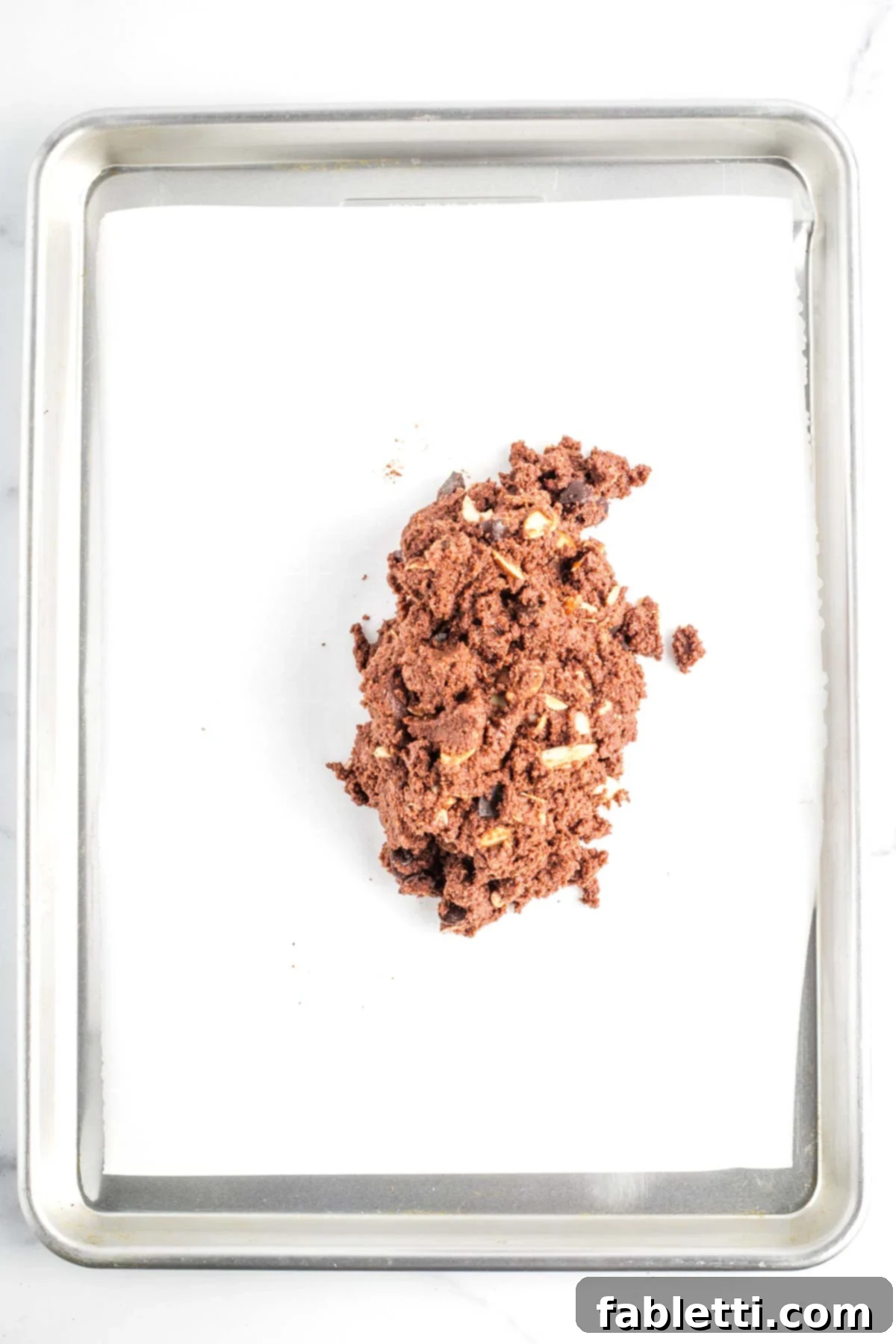 Irresistible Vegan Gluten-Free Chocolate Almond Biscotti 10 Chocolate biscotti batter turned out onto a parchment lined baking tray.