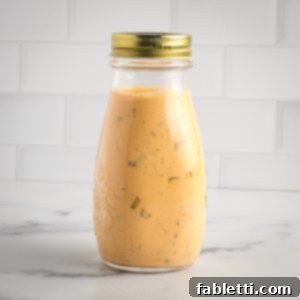 Creamy Tofu Vegan Big Mac Sauce 11 Bottle of burger sauce that's orangish with bits of pickles showing.