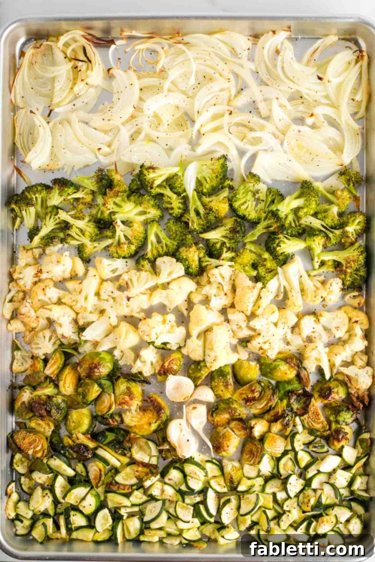 Sheet Pan Green Velvet Soup 8 Rows of roasted onion, broccoli, cauliflower, zucchini and garlic cloves.
