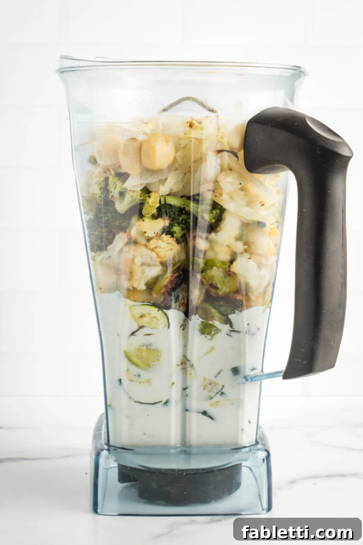 Sheet Pan Green Velvet Soup 9 Cashew cream and roasted vegetables in the pitcher of a blender.