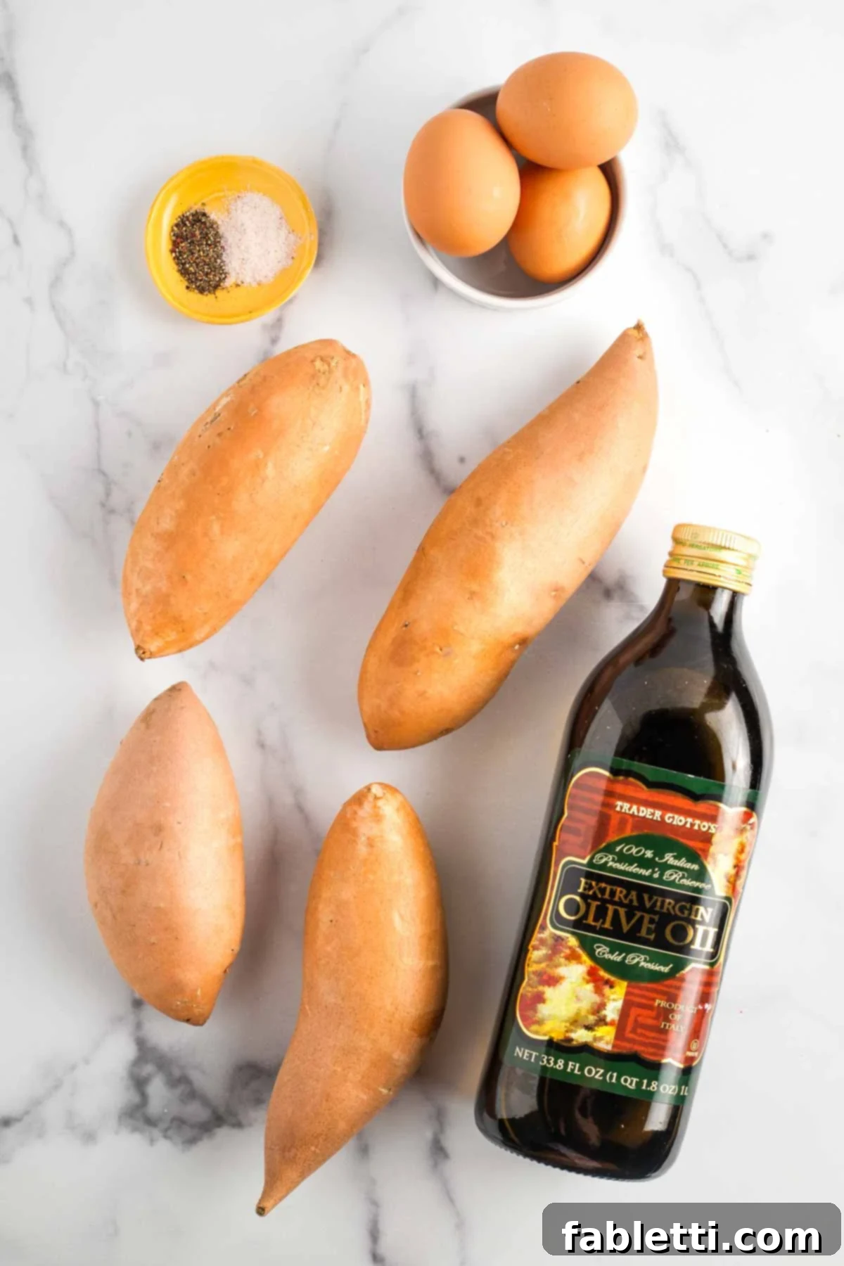 Golden Sweet Potato Kugel Cups 3 Sweet potatoes, brown eggs, bottle of olive oil, dish with salt and pepper.