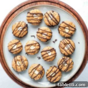 Decadent Vegan Chocolate Almond Macarons 22 Almond macaroon cookies, bottoms dipped in chocolate and tops decorated with an almond slice and then drizzled with chocolate.