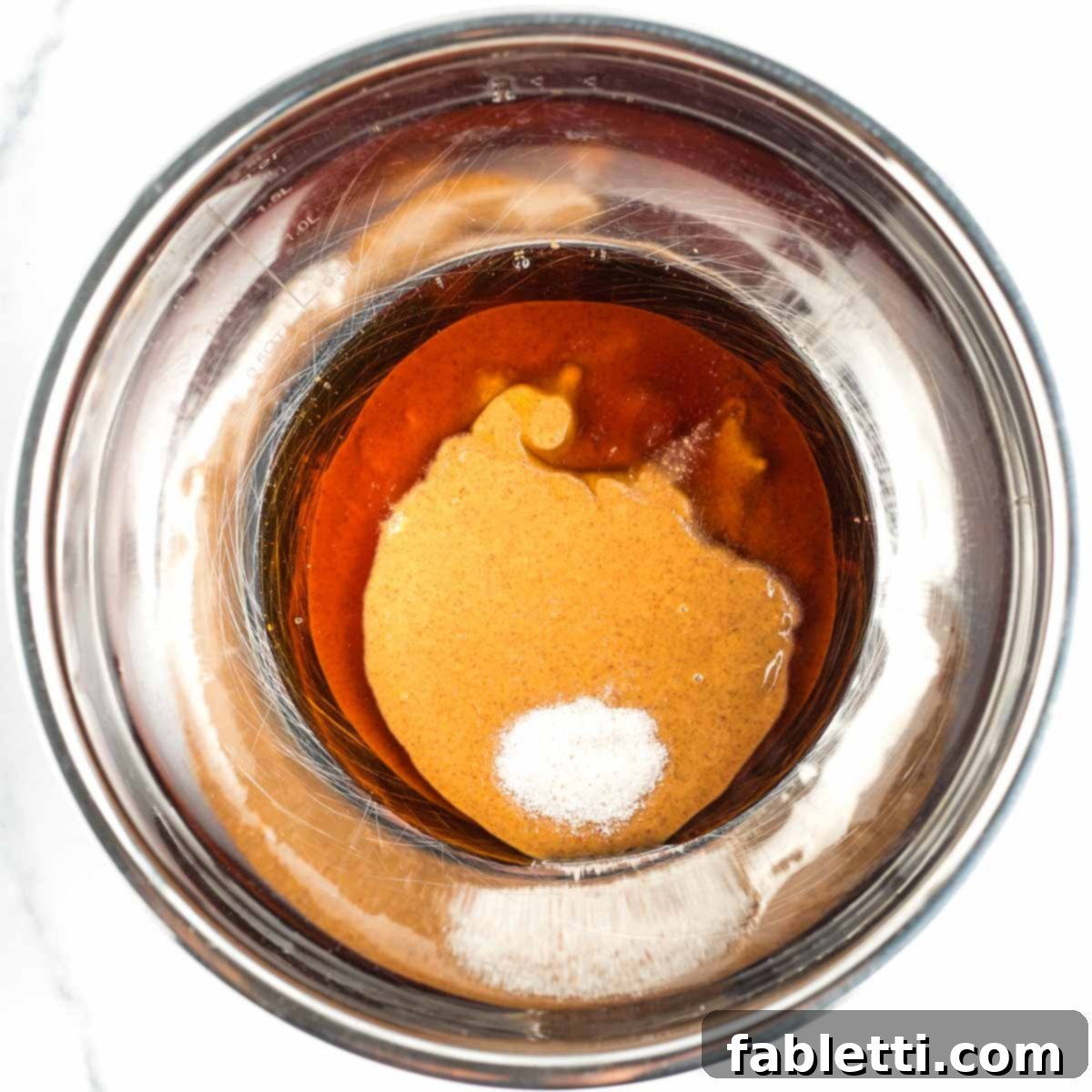 Decadent Vegan Chocolate Almond Macarons 4 Mixing bowl containing almond butter, maple syrup, and sea salt.