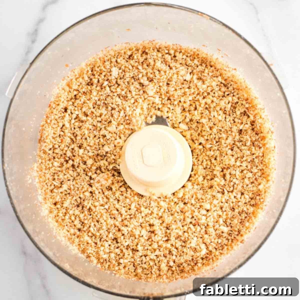 Decadent Vegan Chocolate Almond Macarons 7 Crumbly, coarse grind of nuts in the bowl of a food processor.