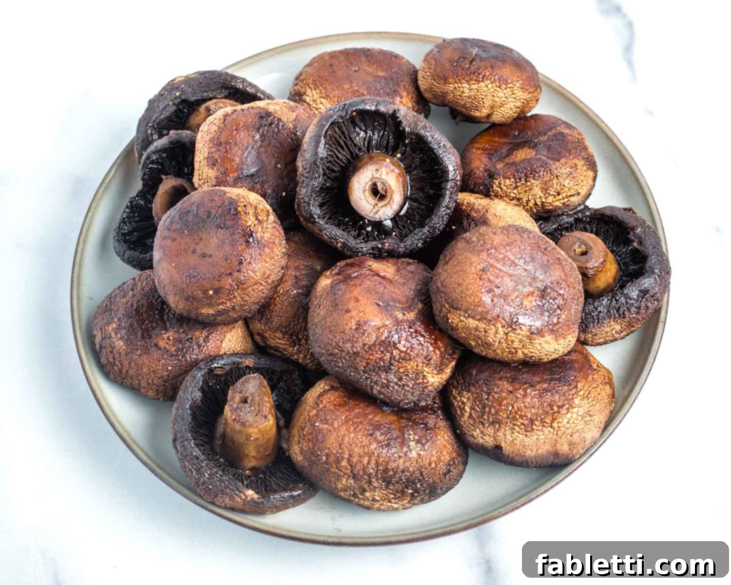 Zesty Chimichurri Portobello Steaks 13 Bowl filled with whole roasted mushrooms.