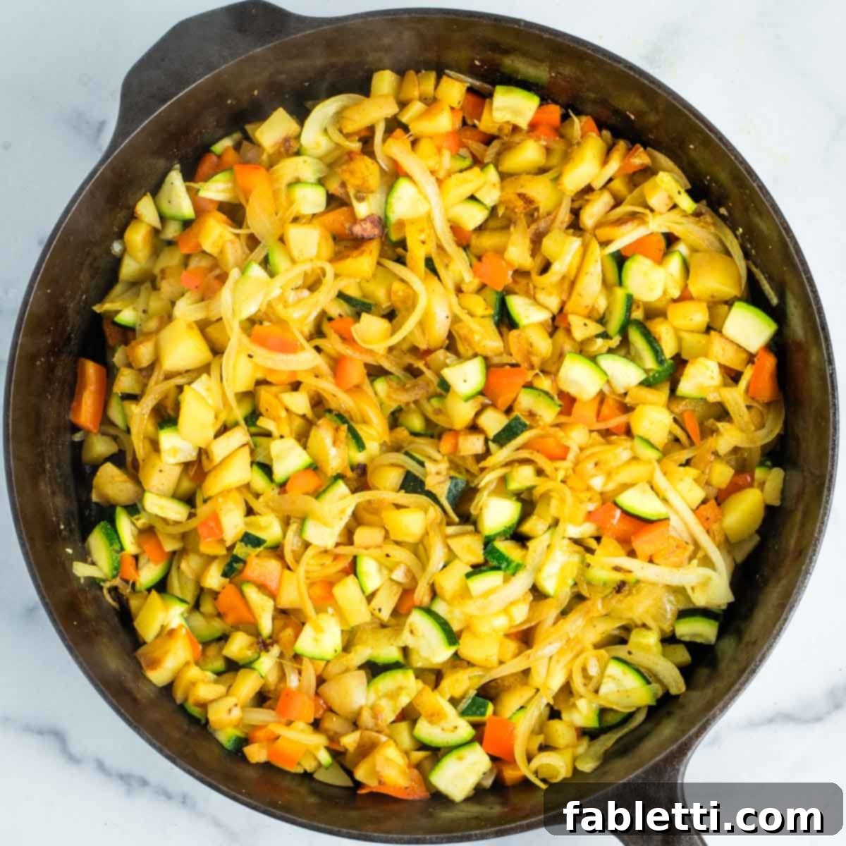 Simple Skillet Vegan Potato & Vegetable Hash 13 Mixed vegetables in a skillet with a splash of water, cooking to perfection for the vegan hash.