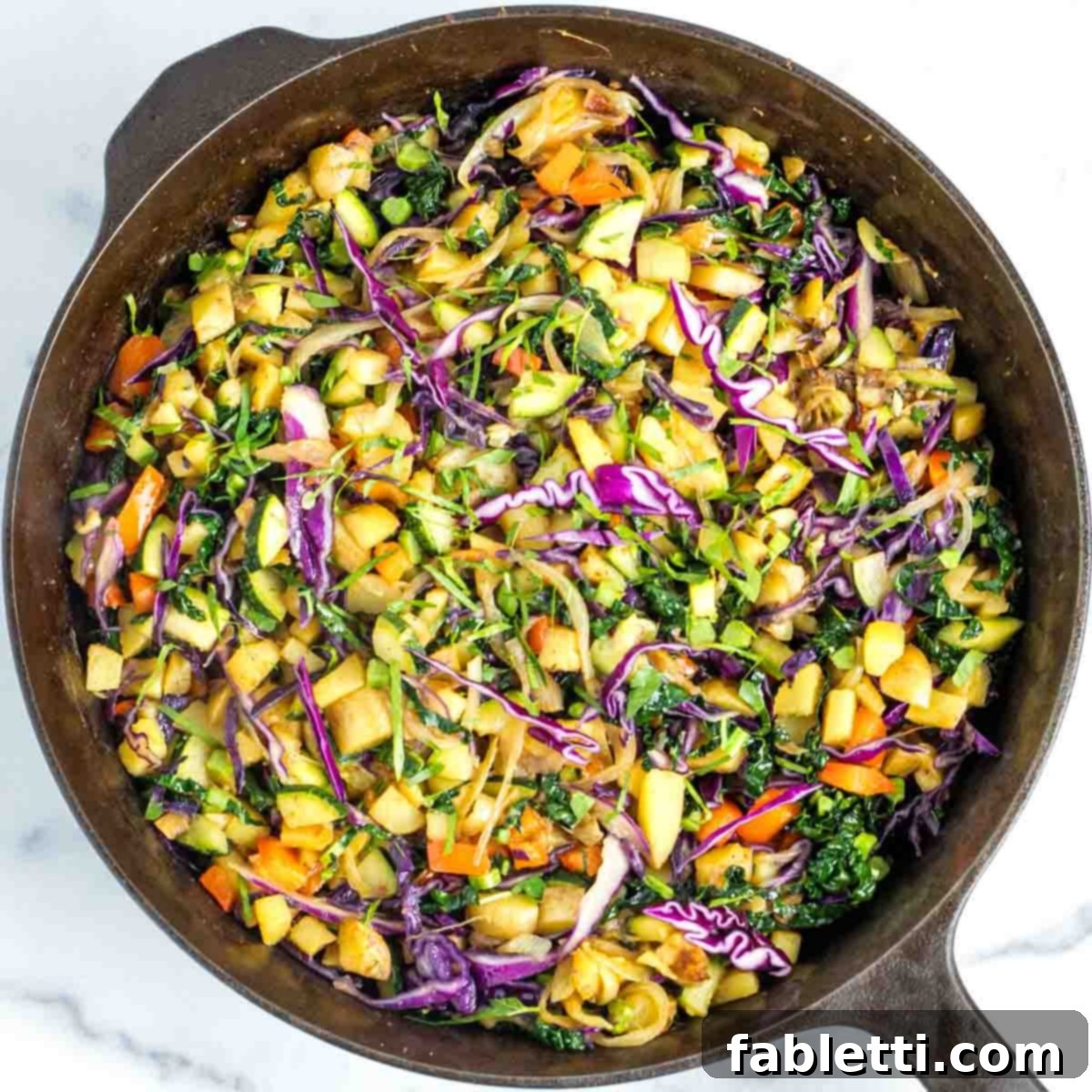 Simple Skillet Vegan Potato & Vegetable Hash 15 A perfectly cooked vegan potato and veggie hash in a skillet, ready to be seasoned and served, with steam gently rising.