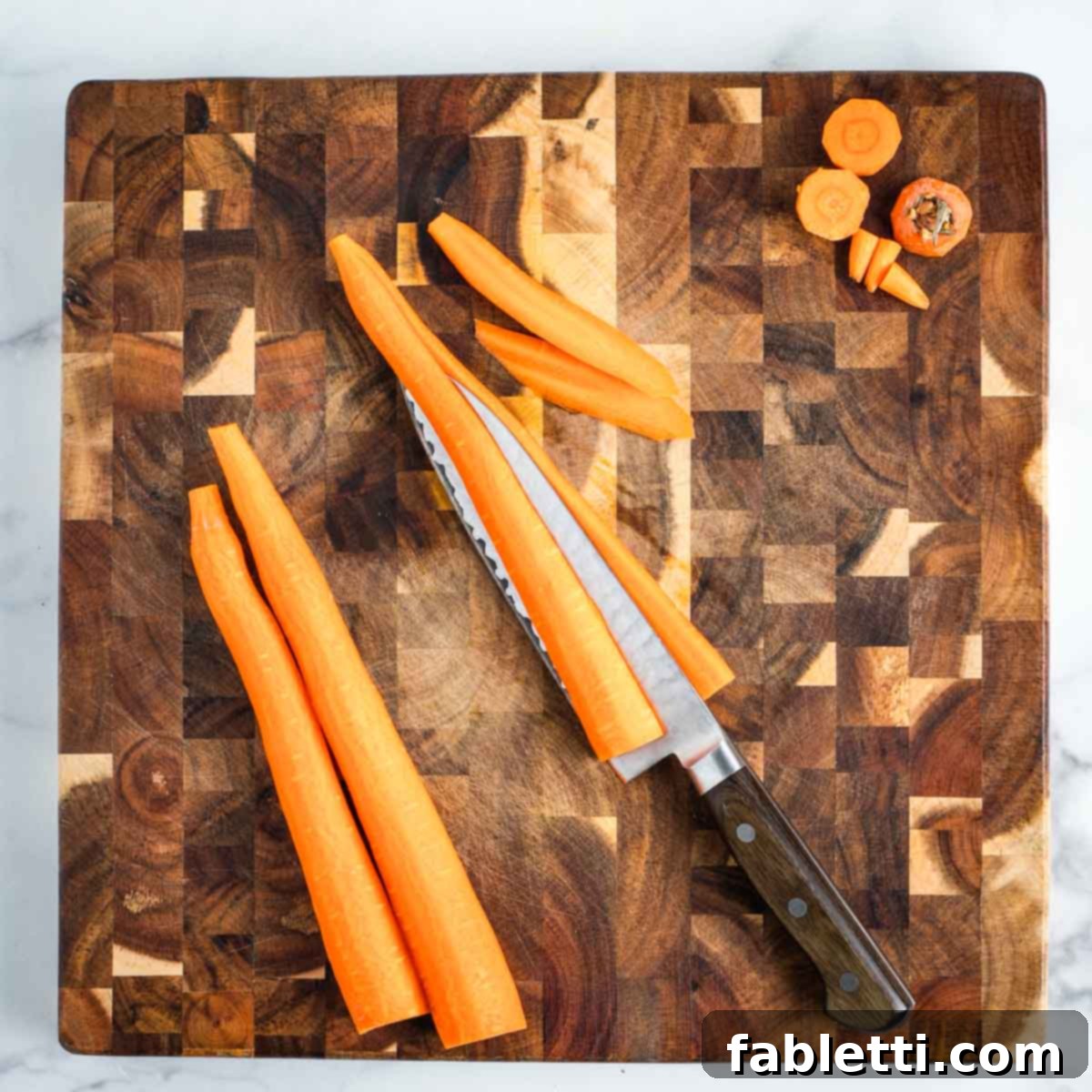 Cutting through carrots lengthwise.