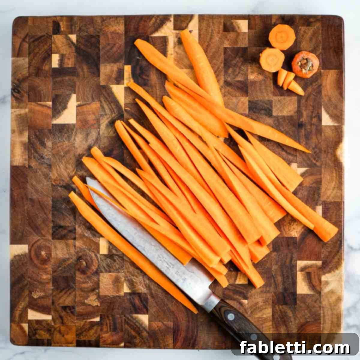 Cutting carrots into long strips. 