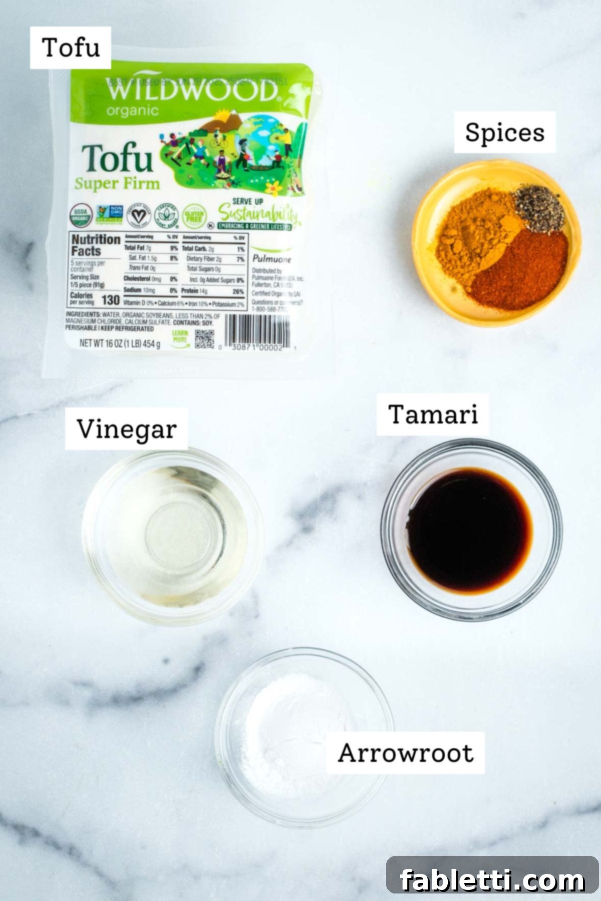 Labeled ingredients: package of super firm tofu, vinegar, tamari, spices and arrowroot powder. 