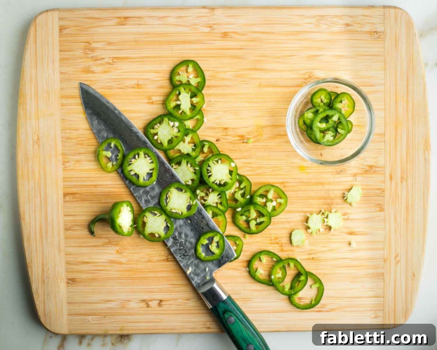 Fresh Spring Roll Salad Bowl with Creamy Peanut Sauce 12 Slicing thin pieces of jalapeno, and pulling out the membranes and seeds from the center of the slices.