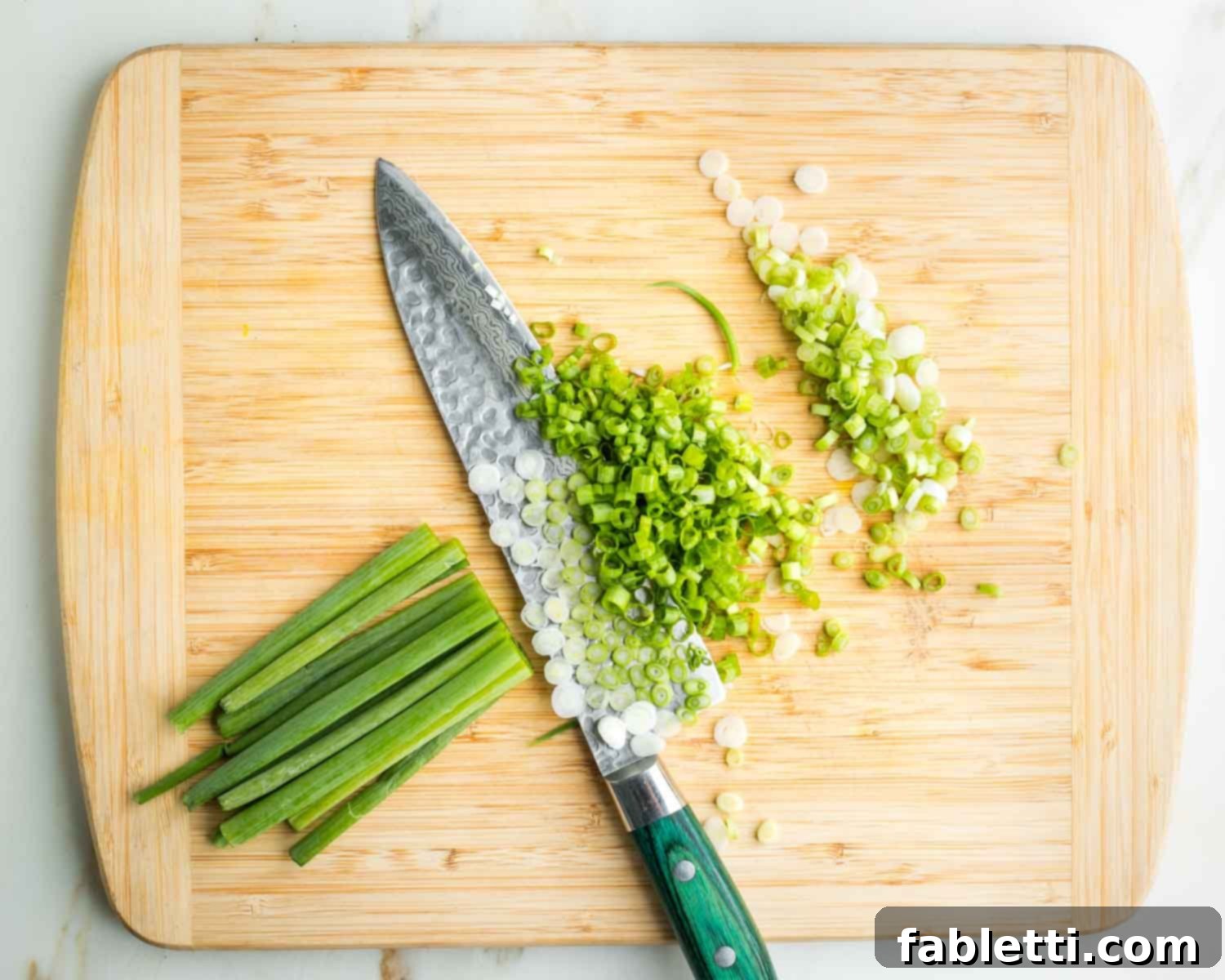 Fresh Spring Roll Salad Bowl with Creamy Peanut Sauce 13 Thinly slicing white and green parts of scallions.