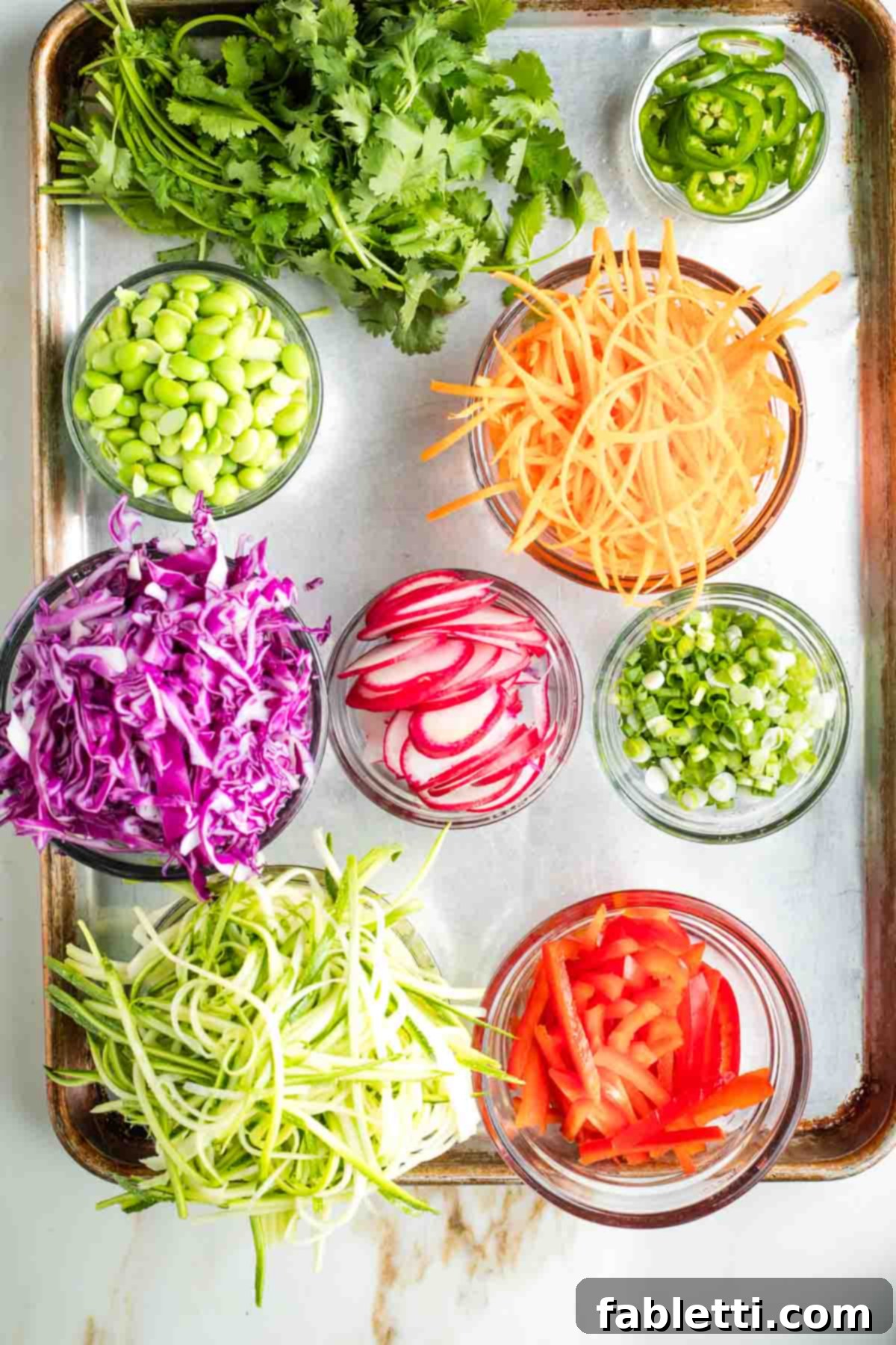 Fresh Spring Roll Salad Bowl with Creamy Peanut Sauce 15 Small bowls with julienned carrots, cabbage, zucchini, red peppers and thinly sliced radish, scallion, jalapenos. plus cilantro and edamame beans.