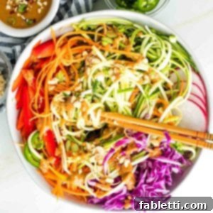Fresh Spring Roll Salad Bowl with Creamy Peanut Sauce 21 Zucchini noodles, carrot ribbons, red peppers, cabbage and radish with peanut sauce drizzled over and peanuts, scallions and jalapenos sprinkled on top.