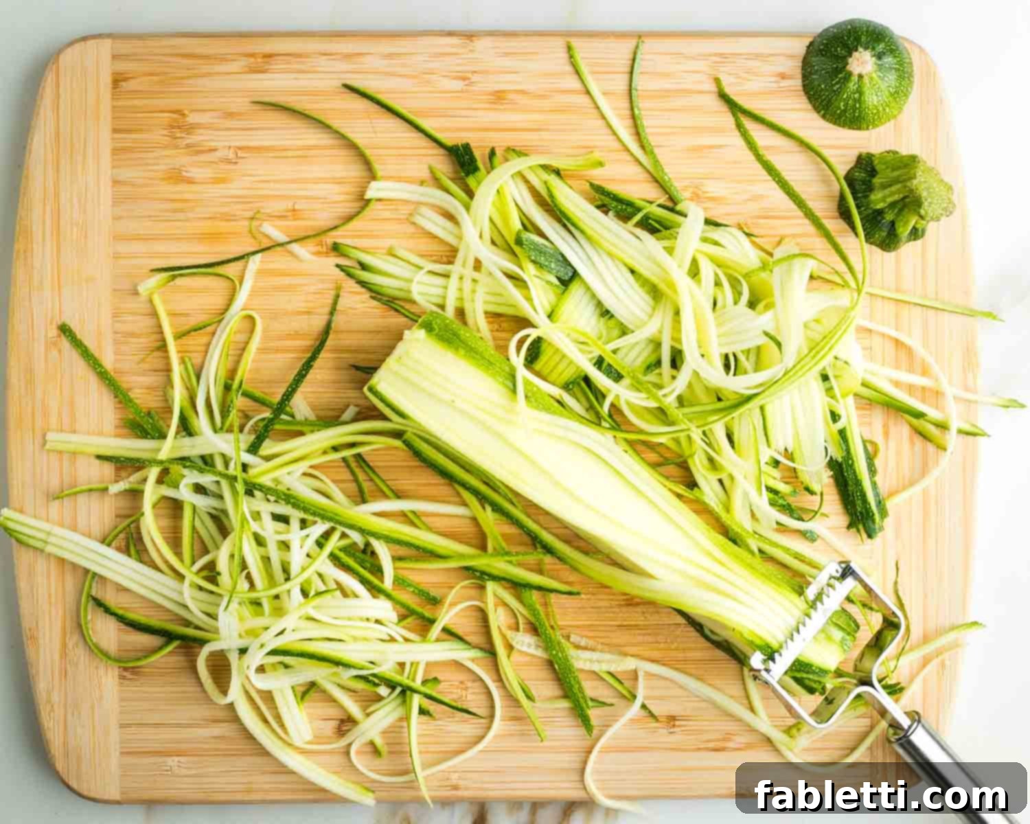 Fresh Spring Roll Salad Bowl with Creamy Peanut Sauce 9 Julienne peeler making thin strips of zucchini.
