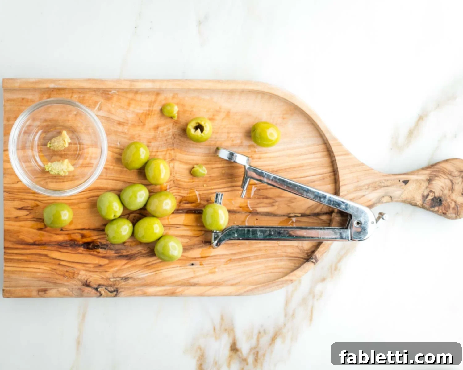 Zesty White Bean Puttanesca Pasta 4 Olive pitter, removing pits from castelvetrano olives.