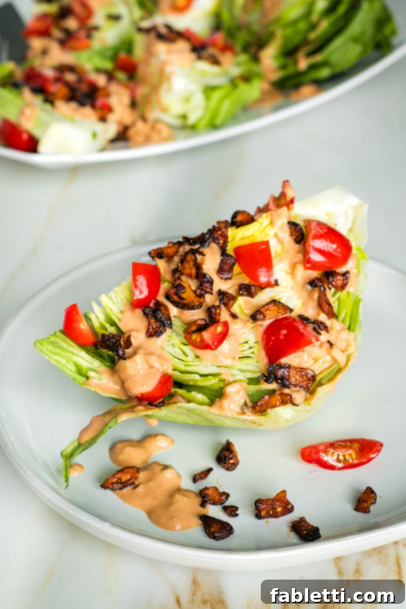 Smoky Shiitake and Zesty Russian Vegan Wedge 2 A crisp wedge of iceberg lettuce generously drizzled with vibrant vegan Russian dressing, topped with savory shiitake bacon crumbles and fresh chopped tomatoes.
