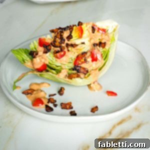 Smoky Shiitake and Zesty Russian Vegan Wedge 17 Wedge of iceberg lettuce with russian dressing, vegan bacon crumbles and diced tomatoes.